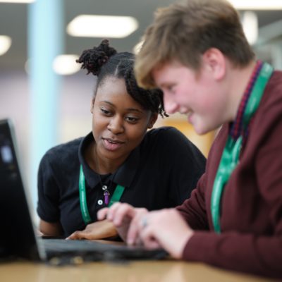 Students working at a laptop