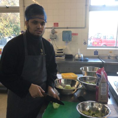 CooO'Shea Rattu preparing food in the training kitchen