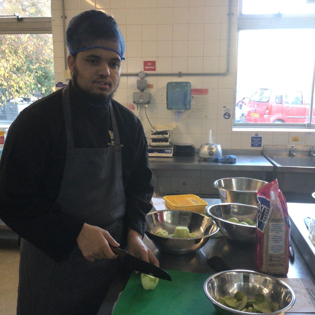 CooO'Shea Rattu preparing food in the training kitchen