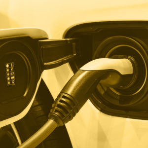 Mustard-tinted picture of an electric charging point in a car