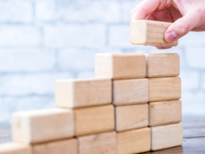 a set of bricks being put down upwards to show progress