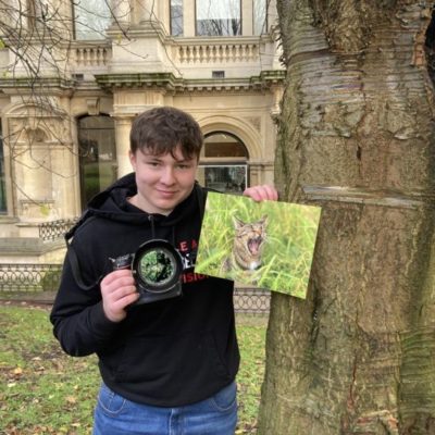 Photography student Devon Beckett pictures outside Wolverhampton Art Gallery, holding a camera and his award-winning picture of his pet cat