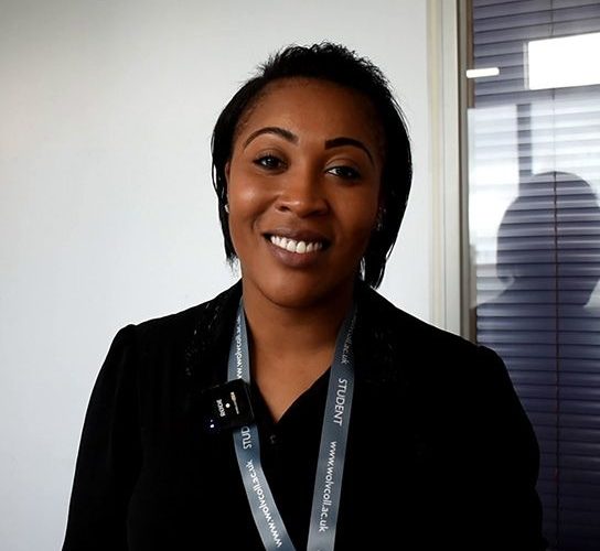 Student Hasina Riley wearing a black top and a grey college lanyard