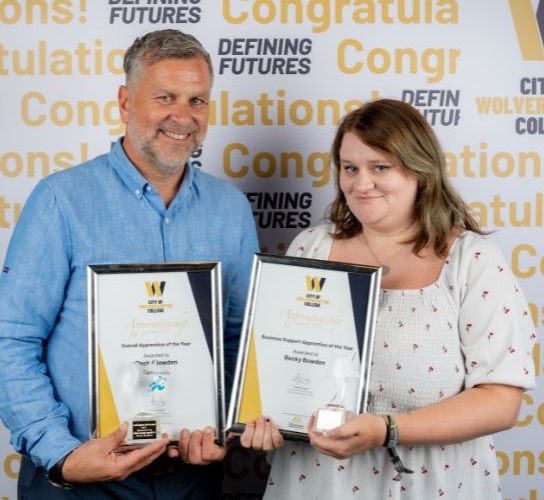 Apprentice of the Year, Becky Bowden, wearing a white top, holding a certificate and trophy with John Harper, managing director of Complesso Healthcare Solutions wearing a blue shirt.