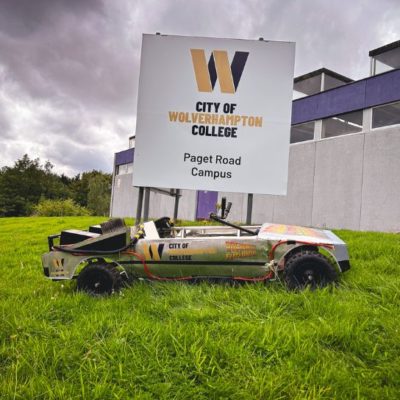 The college's Krazy Races kit kart, branded with the college logo, under the college sign at the Paget Road campus