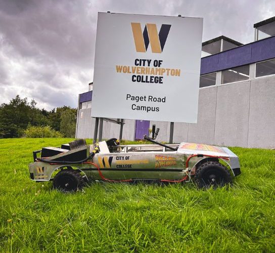 The college's Krazy Races kit kart, branded with the college logo, under the college sign at the Paget Road campus