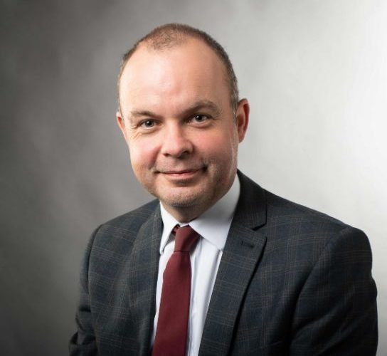 New head of apprenticeships Richard Hewitt wearing a dark jacket, white shirt and maroon tie